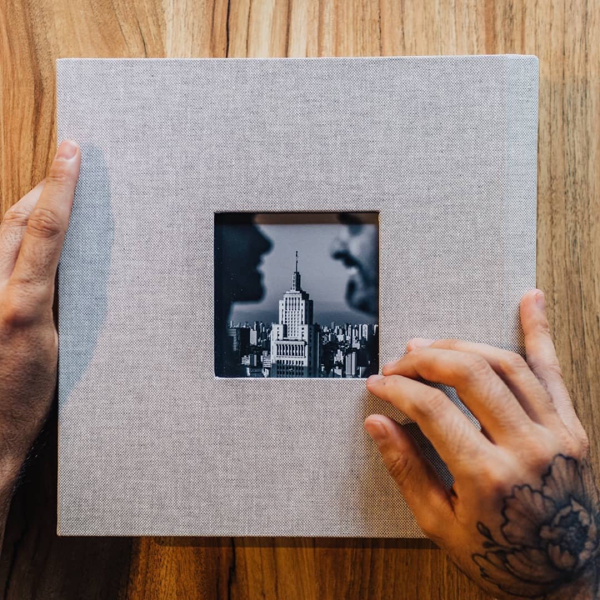 Álbum de fotografias aberto sobre uma mesa.